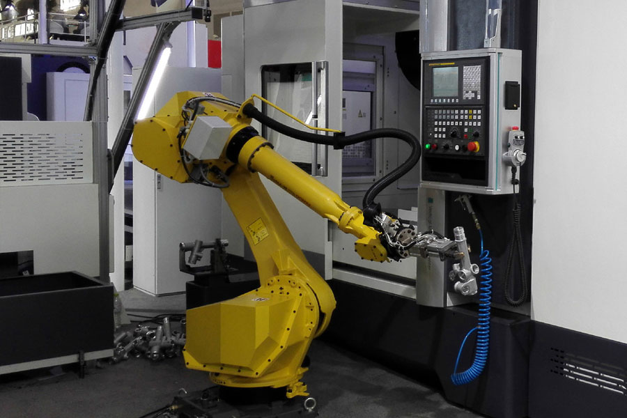 L'applicazione del carico e dello scarico della lavorazione di robot industriali