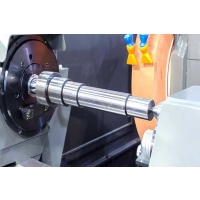 How does the axle affect the performance of a precision grinder?